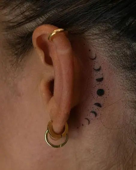 40 Enchanting Moon Phases Tattoo Ideas Moon Phases Tattoo Ear, Moon Cycle Tattoo Behind Ear, Moon Phase Mandala Tattoo, Small Phases Of The Moon Tattoo, Moon Phases Ear Tattoo, Phase Of Moon Tattoo, Moon Phase Shoulder Tattoo, Unique Moon Phase Tattoo, Moon Phases Tattoo Simple