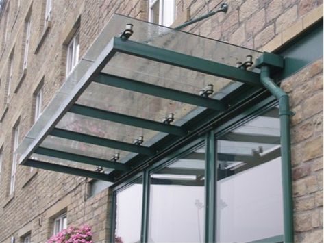 A fully decorated mild steel support framework fixed back to internal steelwork provided the basic design for this attractive individual canopy unit. Support tension rods gave extra stability to the design. All steelwork was fully decorated using our standard heavy duty exterior grade enamel paint system, which is available in any standard BS or RAL Canopy Glass, Glass Canopy, Awning Shade, Tension Rods, Awning Canopy, Canopy Design, Shop Front, Basic Design, Canopies