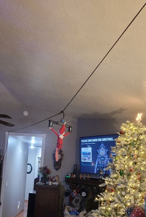 Lightweight cord, clothes hanger and some thumb tacks ;) Elf Zip Line Ideas, Zipline Elf On The Shelf, Elf On The Shelf Ideas Zipline, Zip Lining Elf On The Shelf, Elf On The Shelf Zip Line Ideas, Zip Line Elf On Shelf, Elf Zipline Ideas, Elf Zipline, Elf On The Shelf Zipline