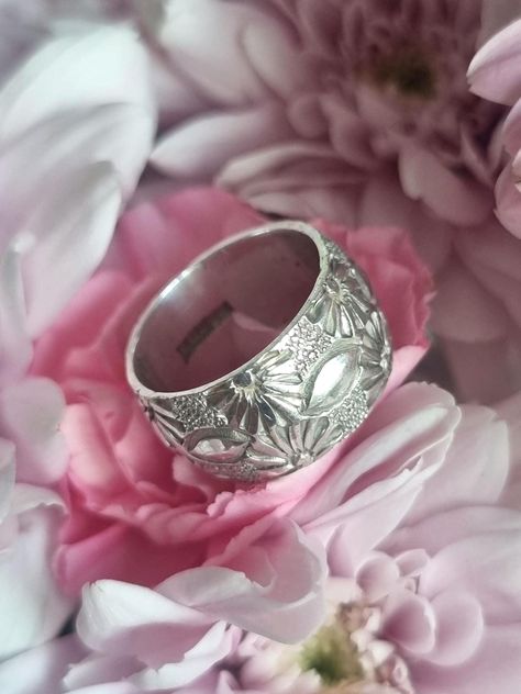 This is a lovely vintage sterling silver wedding band ring. It has a fantastic deep engraved flower design. It's really unusual and eye catching.  Fully hallmarked for sterling silver, it has the Birmingham assay office mark and the date letter Y for 1973.  The ring measures a size L on my ring sizer. I would say it would probably feel more comfortable on a finger that is size K to K 1/2 UK. 5.5 US. I usually wear a size L and this is a little tight on my finger and I have trouble getting it off Wide Wedding Bands, Silver Wedding Band, Engraved Flower, Letter Y, Sterling Silver Wedding Band, Wedding Band Ring, Sterling Silver Flowers, Ring Sizer, Silver Gifts