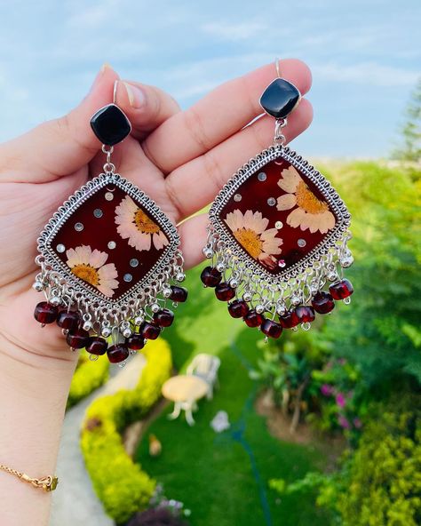 Dark Red Resin Jhumkas Customisation is also available Price: 3000/- Type: lightweight and easy to wear . . . #resinart #jewelry #earrings #rosé #petals #preservation #memories #memoriespreserved #jhumkas #necklace #ring #smallbusiness #hardwork #womenempowerment #workingwomen #rings #necklace #handcrafted #handmade #withlove #foryoupage #explore #reels #reelsinstagram #foryou #accessories Resin Jhumka Earrings, Resin Jhumka, Earrings Jhumka, Resin Jewelry Diy, Traditional Jewellery, Rings Necklace, Resin Tutorial, Necklace Ring, Jhumka Earrings