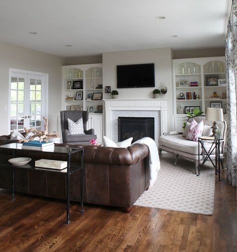 Like the chairs/chaise next to the fireplace. wall color benjamen moore classic grey.A Light, Airy, and Family-Friendly Living Room. Chesterfield couch potterybarn. dwell studio curtains.Tray and driftwood @elise West elm #mywestelm sofa @rh_gallery #restorationhardware mirror & lamps @Karen Jacot Jacot Jacot Crump Designs #ballarddesigns art @Alice Cartee Cartee Cartee Cartee Lane Home Collection #alicelanehome: Family Friendly Living Room, Grey Walls Living Room, Leather Couches Living Room, Brown Living Room Decor, Brown Couch Living Room, Brown Leather Couch, Flat Screen Tv, Living Room Update, Brown Furniture