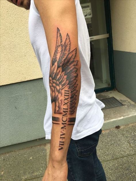 roman-numerals-arm-tattoo-fallen-angel-tattoo-angel-wing-man-with-white-top-jeans Wing Tattoos On Back, Wing Tattoo Men, Back Of Arm Tattoo, Tattoo Placements, Female Tattoos, Men Tattoos, Forarm Tattoos, Tattoo Inspiration Men, Forearm Sleeve Tattoos