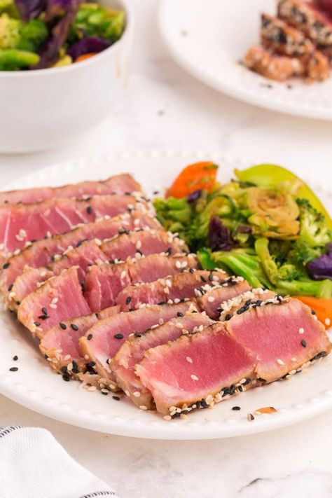 These Grilled Ahi Tuna Steaks are marinated in a flavorful soy sauce and honey marinade then perfectly seared on each side. Steak Calories, Grilled Ahi Tuna, Tuna Steak Marinade, Honey Marinade, Ahi Tuna Steaks, Tuna Steak Recipe, Ahi Tuna Steak Recipe, Grilled Tuna Steaks, Ahi Tuna Steak