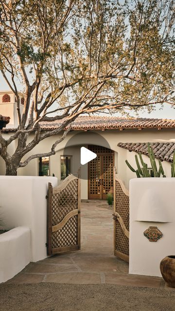 Modern Nest on Instagram: "Welcome to the #mnSantaFeHacienda exterior! This breathtaking design beautifully embodies the spirit of Santa Fe, featuring vibrant Saltillo tile, reclaimed Chicago brick surrounding the pool, hand-selected antique gates, and a custom Spanish cedar door. Each detail invites you to embrace the charm of Santa Fe living, seamlessly blending comfort and style.

Interior design & Build: @modern_nest
Furnishing: @marketbymodernnest
Photography: @modern_nest & @danryan.studio

#ModernNest #ModernNestHomes
——
Interested in owning this special Modern Nest home? See the link in our bio or contact Nick Carlson (480) 200-9471 or Ken Binder (480) 977-0606 @carlsoncollective.

#MarketbyModernNest #SouthwestHomes #southwestdecor #southwestdesign #santafehomes #santafe #santafed Sante Fe Style Homes, Spanish Style Front Porch, Spanish Style Driveway, Santa Fe Style Homes Interiors, Spanish Homes Exterior, Southwestern Home Exterior, Modern Spanish Style Homes Exterior, Modern Adobe House Exterior, Adobe House Exterior