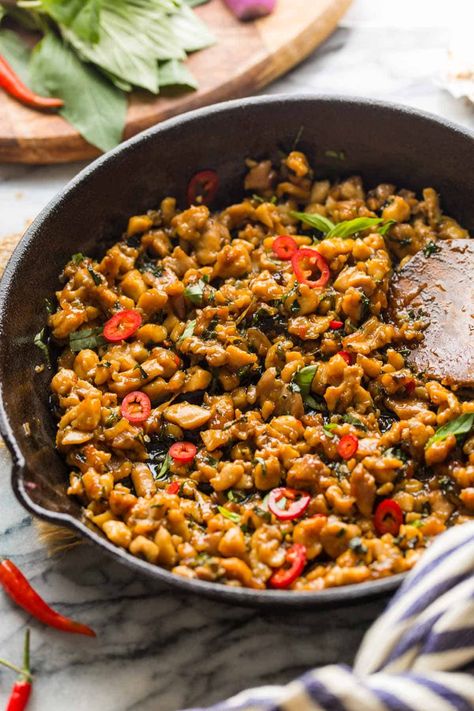 Spicy Thai Basil Chicken (also known as Pad Krapow Gai or Phat kaphrao) - is everything you want from a stir-fry. It's simple, speedy, straight satisfying! It's no wonder that Pad Krapow Gai is an extremely popular Thai street food dish and a staple in Thai cooking in general. Make this easy stir-fry in about 15 minutes, serve over a bed of rice and enjoy! Spicy Thai Basil Chicken, Pad Krapow, Thai Basil Chicken, Easy Stir Fry, Spicy Thai, Thai Cooking, Thai Street Food, Basil Chicken, Street Foods