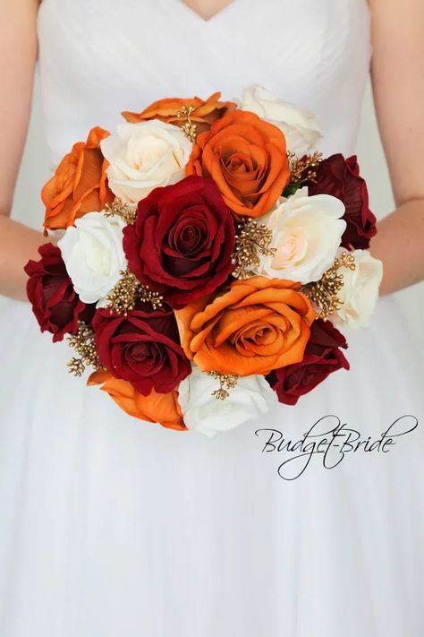 This is a round brides bouquet with a mixture of dark red, ivory and burnt orange roses accented with gold berries. All of our wedding bouquets are made with artificial wedding flowers. Wine Wedding Flowers, Red Rose Boutonniere, Bridal Colors, Wedding Boat, Gold Wedding Flowers, Shell Wedding, Orange Wedding Colors, Orange Wedding Flowers, Burnt Orange Weddings