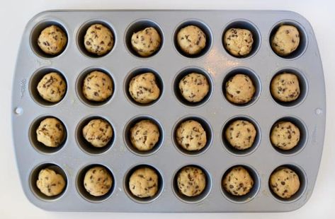 A mini muffin tin containing balls of unbaked chocolate chip cookie dough Mini Muffin Cookies, Cookies In Mini Muffin Tins, Cookies In Muffin Tin, Chocolate Chip Cookie Muffins, Pillsbury Chocolate Chip Cookies, Mini Muffin Tin Recipes, Mini Chocolate Chip Muffins, Chocolate Chip Cookie Cups, Mini Cupcake Pan