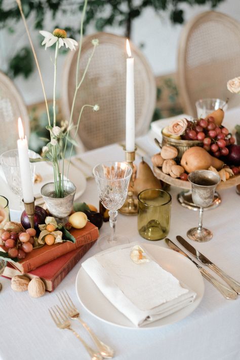 Ikebana arrangements, scattered nuts + fruits across the tablescape and a flowy wedding dress that belongs in a ballet? This European harvest wedding inspiration is a dream! These ideas are the perfect solution for weddings that may not be able to happen overseas, but that still capture that Old World romance aesthetic we all love. Head to Ruffled to see the rest of the design details from the love script cake to the wildflower crescent ceremony backdrop now! #autumnvibes #flowyweddingdress #wil Fall Harvest Wedding Theme, Candle Heavy Tablescape, Fruit Tablescape Wedding, Ikebana Tablescape, Vegetable Tablescape, Fruit Table Wedding, Fruit Centerpieces Wedding, Fall Wedding Table Decorations, Harvest Tablescape