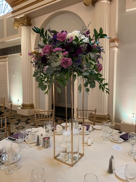 Deep Purple Centerpieces, Purple Gold And White Centerpieces, Purple Centerpiece Tall, Elevated Floral Centerpieces, Purple Floral Centerpieces, Purple Wedding Flowers Centerpieces, Tall Gold Vases, Dark Purple Wedding, Gold Wedding Centerpieces