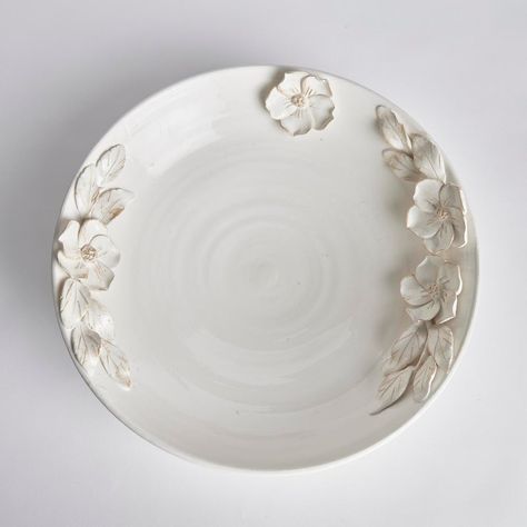 Each and every dogwood flower and leaf detail of the Fiori Decorative Grande Bowl is handmade, and hand-applied by Italian artisans in Tuscany, Italy. A seamless design in a soft white glaze and delicate antiquing along petal edges. With a classic Italian craftsmanship passed down through generations, each piece is a true original. In grand scale, a dynamic centerpiece for feature table, kitchen island or mantel.  Designer floor samples & new product from one of the hottest To The Trade & Retail Home Furnishings showrooms in the country. Located in Chicago's chic Roscoe Village, Kenneth Ludwig Chicago carries the industries best furniture & accessory brands. Always fresh, always inspiring. Quite often ( due to a discontinued style, fabric or frame ) they must sell off their showroom floor Dining Room Lighting Chandeliers, Table Kitchen Island, Dogwood Flower, Dogwood Flowers, Clay Bowl, Ceramic Color, Flower Bowl, Leather Pillow, Italian Craftsmanship