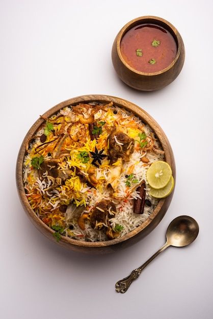 Mutton or lamb biriyani with basmati ric... | Premium Photo #Freepik #photo #mutton-biryani #biryani #basmati-rice #rice-dish Mutton Biryani Photography, Biriyani Photos, Biryani Plating, Mutton Biriyani, Indian Food Menu, Lamb Biryani, Moody Background, Lamb Rogan Josh, Indian Food Photography