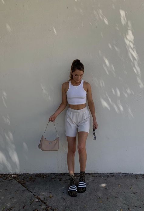 white halter tank top paired with grey or gray sweatshorts long socks and sandals or slide and a purse and sunglasses #accessories #purse #glasses #ponytail #lazy #chill laidback outfit. ponytail hairstyles.  Pink prada purse Gray Sweatshorts Outfit, Outfits With Sweatshorts, Sweatshorts Outfits, Grey Shorts Outfit, Slides Outfit, Shorts Outfits Women, Model Outfit, Thrifted Outfits, 90s Fashion Outfits