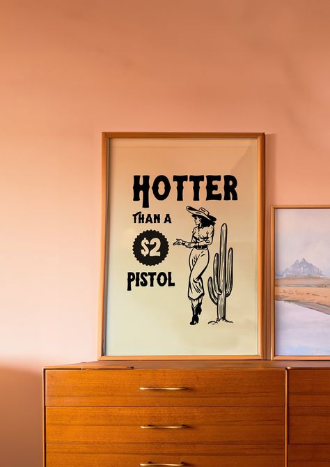 Saddle up and embrace the wild spirit of the open range with our 'Hotter than a 2 dollar pistol' Cowgirl Retro Print. This retro wall art captures the essence of adventure, freedom, and the untamed West. ---------------------------------------------------- Features: Experience art that feels silky to the touch with our high-quality, lighter-weight, classic semi-glossy paper, making it perfect for creating long-lasting prints. We also use FSC-certified paper or equivalent depending on availabilit 70s Western Home Decor, Cosmic Cowgirl Decor, Retro Western Decor, 70s Western Aesthetic, Western Apartment Decor, Western Art Prints, Cowgirl Bedroom, Cowgirl Decor, 70s Art