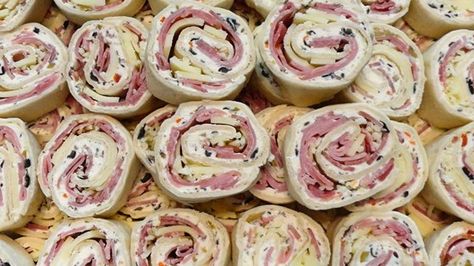 Tortilla rolls filled with ham, salami, cheese, and an olive salad make an appetizer sized version of the New Orleans traditional sandwich. Muffuletta Salad, Horderves Appetizers, Muffuletta Sandwich, Pizza Pinwheels, Tortilla Rolls, Pinwheel Recipes, Appetizers And Dips, Mardi Gras Party, Provolone