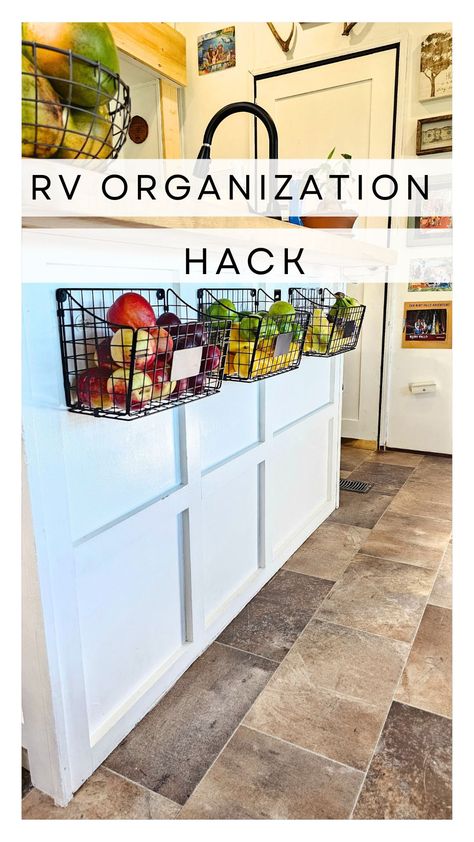 RV trailer kitchen with hanging adhesive organization baskets Living In A Camper Full Time Storage Ideas, Rv Wall Storage, Camper Living Full Time Organization, Living In A Camper Full Time, Full Time Rv Living Hacks, Rv Living Full Time Rv Organization, Camper Living Full Time, Rv Living With Kids, Camper Patio