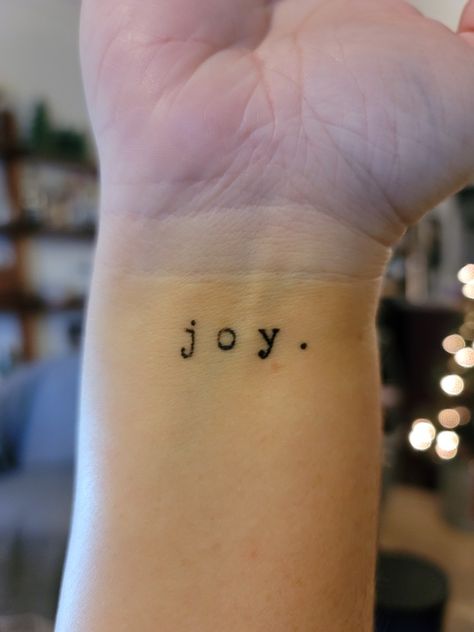 Small Joy wrist tattoo in typewriter font Joy Tattoo Ideas Design, Joy Name Tattoo, Joy Tattoo Fonts, Joy Wrist Tattoo, Joy Tattoos For Women, Count It All Joy Tattoo, Joy Comes In The Morning Tattoo, Small Side Wrist Tattoos For Women, Tattoo Typewriter Font