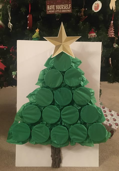 2 pieces of green tissue paper cover the red solo cups to create this tree.  Inside you can place whatever items you want - money, lottery tickets, candy, gift cards, lumps of coal, kids toys, etc.  For the game you can number and let each person pick a number to punch and that keeps the gifts close to the same amount or you can play high low card and whoever gets the highest card gets to punch a cup and keep what is in side.  This can be fun for children and adults of all ages. Christmas Tree Game, Shop Board, Christmas Gift Games, Fun Christmas Party Games, Fun Christmas Games, Christmas Punch, Christmas Games For Family, Holiday Party Games, Family Christmas Party