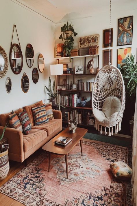 This cozy bohemian living room boasts vintage furniture, a comfy sofa, and a stunning hanging chair. The room is filled with greenery, colorful textiles, and an array of eclectic decor pieces, creating a warm and welcoming atmosphere that exudes boho charm. #bohemianlivingroom #vintagefurniture #hangingchair #bohodecor #indoorplants #cozy livingspace #eclecticstyle #colorfultextiles #bohohome Living Room Boho Vintage, Boho Artsy Living Room, Vintage Bachelor Pad, Bohemian House Decor Living Room, Living Room Decor Cozy Vintage, Boho Retro Living Room, Boho Vintage Living Room, Cozy Vintage Apartment, Indie Living Room