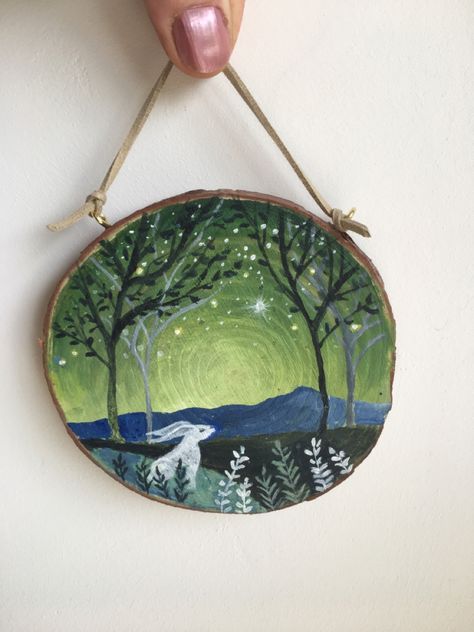 ‘Looking Up’  An original, acrylic painting of a hare in the countryside, overlooked by some shining stars.  The painting is on a natural wood slice, with a suede tie for hanging.  Each piece of wood is unique in size, shape, pattern and texture. Each painting is individual. I enjoyed painting this little white hare, looking up at the magical, night sky.  I have initialled the front of the painting and my full signature is on the back of the wood.  This artwork is ideal if you would like to buy Wooden Disc Painting Ideas, Wood Log Painting, Locker Pictures, Log Painting, Magical Night Sky, Waldorf Classroom, White Hare, Amanda Clarke, Hare Art