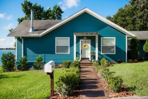 A Little Lake House Cottage Is Now Totally Adorable Thanks to Lots of DIY Sanding Floors, Teal Cottage, Lake House Cottage, Cottage Names, Plaster Repair, House Transformation, Tile Painting, Building An Addition, Old Fireplace