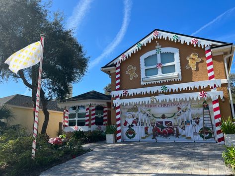 A two-story house which color is ginger, turned into a gingerbread house using insulation foam boards cut and painted into snowdrifts, icicles, candy canes, candies and even gingerbread men. Gingerbread House Real Life, Life Sized Gingerbread House, Gingerbread House Yard Decorations, Lifesize Gingerbread House Diy, Gingerbread House Outdoor Decor, Gingerbread House Decorations Outdoor, Gingerbread House Decorations Life Size, Life Size Gingerbread House Diy, Lifesize Gingerbread House