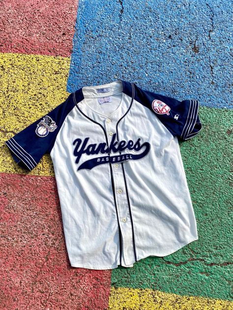 Vintage 90s/2000s New York Yankees MLB Baseball Starter Script Tail Sweep Jersey Size Large        You are viewing a VTG Yankees Jersey     Starter Tag  GOOD Condition Minor cosmetic stains may exist  Cream/Off-White and Blue Jersey! 65% Polyester, 35% Cotton    Measurements: 32" LONG, 23.5" WIDE and 38" SLEEVE-to-SLEEVE  Terms: Vintage clothing sizing varies and may have minor cosmetic imperfections. We recommend measuring one of your favorite pieces to compare! Will ship as soon as possible AFTER receiving payment. Please ask any questions or request more pictures if you have additional concerns. NO RETURNS, sold as is. Vintage Yankees Sweatshirt, 2000s New York, 90s Jersey, Vintage Baseball Jersey, Baseball Jersey Outfit, Clothes 2000s, Yankees Shirt, Yankees Jersey, 90s New York