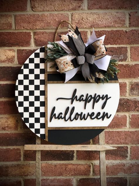 We offer a wide variety of wooden door hangers to spruce up your front door!  Description: Welcome the spooky vibes of Halloween with our modern chic black and white  checkered Happy Halloween Door Hanger, perfect for adding a touch of fun and spookiness to your front door! Handcrafted with care, this door hanger is available in two sizes, 18" and 22", and features high-quality materials and craftsmanship. Product Features: Sizes: Choose between 18 inches and 22 inches in diameter. Thickness: St Goth Door Sign, Checkered Halloween Decor, Diy Halloween Door Sign, Beetlejuice Door Hanger, Fall Door Signs, Diy Door Hangers, Haloween Decor, Black Christmas Tree Decorations, Porch Wood