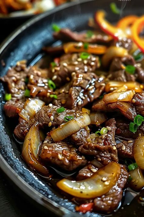 Chinese Pepper Steak with Onions is a delicious and easy stir-fry recipe packed with tender steak, crunchy bell peppers, and a savory sauce. Perfect for a quick weeknight dinner, this 30-minute meal will become a favorite in your home. Serve it with rice or noodles for a complete and satisfying dish. Save this recipe for your next family meal and give it a try tonight! Chinese Pepper Steak With Onions Recipe, Pepper Steak With Onions, Pepper Steak Recipe Easy, Pepper Steak And Onions, Chinese New Year Dinner, Steak With Onions, Steak Stirfry Recipes, Pepper Steak Stir Fry, Chinese Pepper Steak