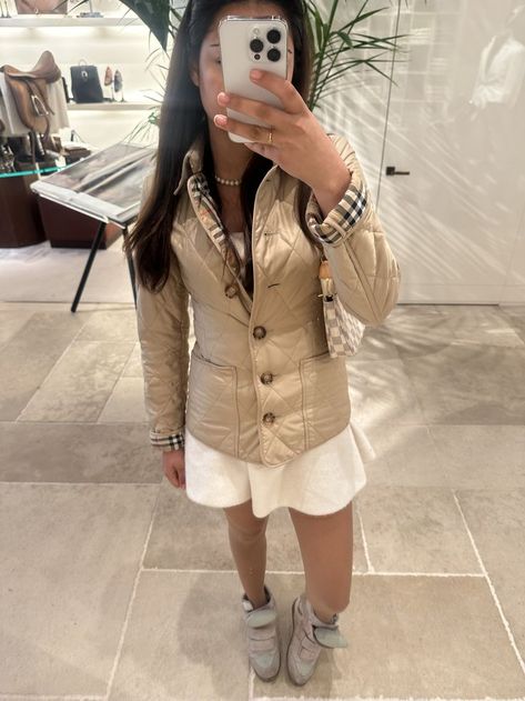 🍂 Effortless Fall Chic! 🍁 Loving this beige burberry jacket with a soft white skirt and suede high-tops. Perfect blend of cozy and luxe for autumn! ✨ #FallFashion #ChicAndCozy #NeutralTones Burberry Jacket Outfit, Fall Chic, Burberry Outfit, Burberry Jacket, Jacket Outfit, White Skirt, Soft White, White Skirts, Jacket Outfits