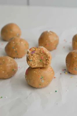 Birthday Cake Protein Balls Packed With Protein and Fiber | Well+Good Birthday Cake Protein Balls, Cake Protein Balls, Protein Cookie Dough Recipe, Birthday Cake Protein Bars, Birthday Cake Protein, Easy Birthday Cake, Cake Batter Protein, Healthy Birthday Cakes, Healthy Birthday