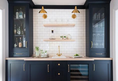 JK Interior Living - Black wet bar with gray wash wooden countertops and a sink with a brass gooseneck faucet under gray wash floating shelves mounted on white subway tiles with gray grout. Navy Kitchen Cabinets, Navy Blue Kitchen Cabinets, Brick Colonial, Home Wet Bar, Navy Kitchen, Basement Bar Designs, Home Bar Design, Kitchen Wall Cabinets, Blue Kitchen Cabinets