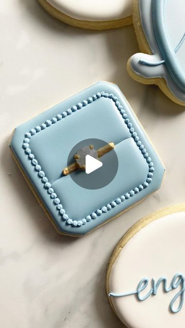 Ronnie’s Custom Cookies on Instagram: "Okay but is your diamond engagement ring edible though?! . . . . . . #cookies #cookier #cookiesofinstagram #cookiedecorating #cookiedecorator #decoratedcookies #cookievideo #cookiereels #cookiereel #cookiedecoratingvideo #cookiedecoratingvideos #engagementringcookies #ringcookies #isomaltsugar #isomalt #isomaltgems #columbusohio #columbuscookies #cookiesofcolumbus #columbusbakery #engagementcookies #weddingcookies" Ring Box Cookie, Ring Box Cookies Decorated, Diamond Ring Cookies, Engagement Decorated Cookies, Engagement Party Cookies Decorated, Wedding Ring Cookies Decorated, Bridal Cookies Decorated, Engagement Cookies Ideas, Isomalt Cookies