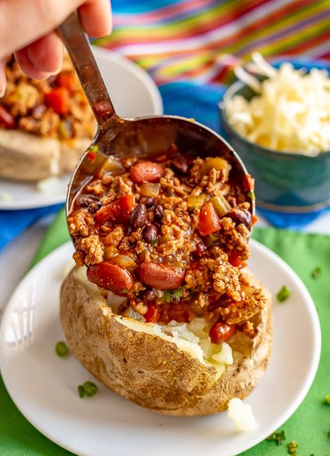 Loaded chili stuffed baked potatoes are the perfect way to use up leftover chili! Tender, fluffy potatoes are filled with warm chili and topped with all your favorite toppings. #chili #potatoes #bakedpotatoes #stuffedpotatoes #easydinner Baked Potatoes And Chili, Chilli Baked Potato Recipes, Baked Potato And Chili, Baked Potato Chili Recipe, Chili Over Potatoes, Chili Loaded Baked Potato, Chili Stuffed Baked Potatoes, Chili And Baked Potato, Chili For Potato Bar