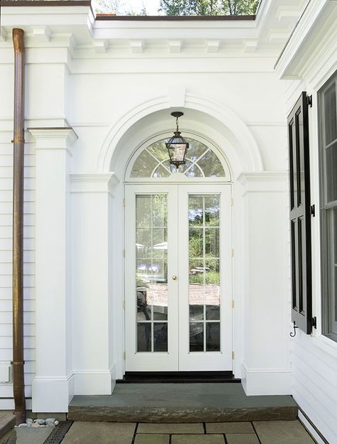 The new French doors and arched transom window mimic the front entryway and provide an easy access to the patio. Arch Transom Windows, Double Front Door With Arched Transom, Doors With Arches, Arched Home Exterior, Arch Window Above Front Door, Arched Doorway Exterior, Front Porch Coastal, French Windows Exterior, Arch Door Entrance