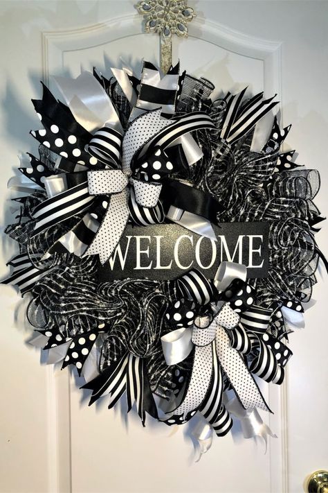 Stunning Black & White Door wreath enhance with a Welcome sign and different patterned black & white ribbons and a large bow.
Can be used year round on your front door, porch or interior walls.  It also makes for an impactful gift.
#wreaths
#front door
# holiday wreath
#porch decor
#welcome Wreath Xmas Ideas Diy, White Mesh Wreath, Round Porch, House Divided Wreath, Black Christmas Decorations, Deco Mesh Crafts, Front Door Interior, Fall Mesh Wreaths, Burlap Mesh Wreath