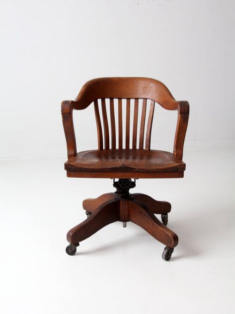 This antique swivel desk chair, made around the 1920s-1930s by the Office Equipment Company of Chicago, has a timeless aesthetic. Its wood frame has a beautiful tone and patina, while its iron adjustable height mechanism allows for versatile use. The perfect addition to any office or study, this classic bankers chair is sure to add charm and character. From our Heritage Collection CONDITION In good condition with wear consistent with age and use.  MEASUREMENTS Height:  31.5"  ..  80 cm Width: 23 French Desk Chair, Aesthetic Chairs Vintage, 1920s Desk, Aesthetic Desk Chair, Desk Chair Aesthetic, Vintage Office Chairs, Antique Desk Chair, Wooden Desk Chair, Wood Desk Chair