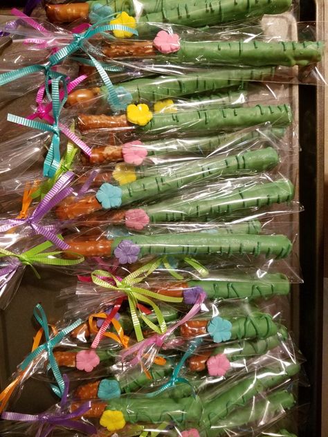 Hawaiian theme pretzel sticks. Hawaiian Pretzel Rods, Hawaiian Candy Table Ideas, Lilo And Stitch Treat Table, Lilo And Stitch Pretzel Rods, Hawaiian Theme Snacks, Hawaiian Luau Party Favors, Lilo And Stitch Dessert Table, Hawaii Snacks Luau Party, Preschool Luau Party Food