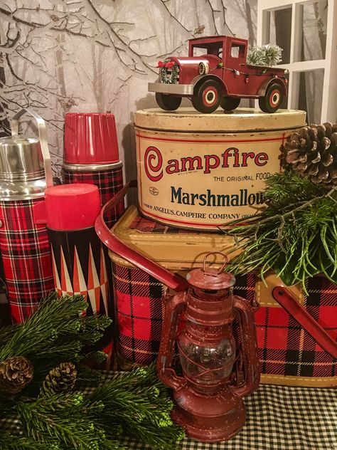 Vintage Thermos Decor Fall, Campfire Marshmallow Tin Decor, Campfire Marshmallow Tin, Vintage Christmas Vignettes, Vintage Christmas Tablescapes, Campfire Christmas, Plaid Thermos, Rv Christmas, Retro Reindeer