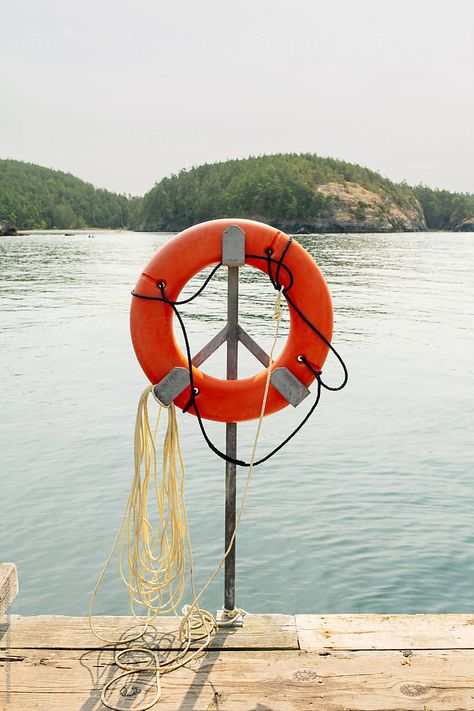 Life preserver water safety ring on a boat dock at Sharpe Cove in Deception Pass State Park, Washington during summer time. River Life Aesthetic, Life Preserver Ring, River Garden, Deception Pass, Life Preserver, Life Ring, River Life, Water Safety, Wooden Poles