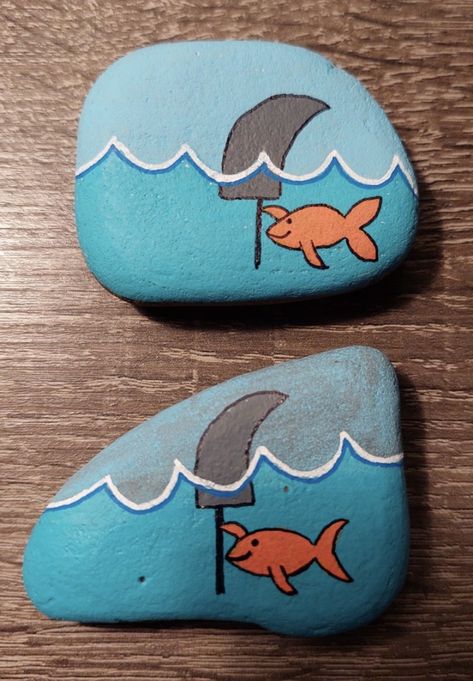 Painted Rocks Shark, Goldfish Rock Painting, Fishing Rock Painting Ideas, Shark Rock Painting Ideas, Fishing Rock Art, Lake Rock Painting Ideas, Fishing Rock Painting, Easy Shark Painting, Shark Painting Easy