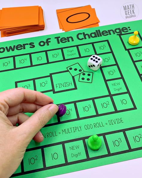 Help students understand what happens to numbers when we multiply and divide by powers of ten using this hands on math game. Students build numbers on their place value mat and then multiply and divide. They also practice seeing and using powers of ten written with exponents. Grab it free! Multiply & Divide by Powers of Ten Game: Includes Exponents Multiplying By Powers Of 10, Teaching Powers Of 10, Multiplying And Dividing By Powers Of 10, Powers Of Ten Anchor Chart, Powers Of 10 Activities, Place Value Mat, 5th Grade Math Games, Printable Math Games, Free Math Games