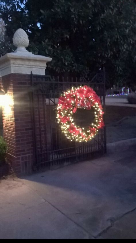 The wreath on the gate I made Wreaths On Driveway Gate, Gate Wreath Ideas, Christmas Gates Entrance, Farm Gate Christmas Decor, Christmas Gates, Christmas Gate Decorations Outdoor, Gate Christmas Decor, Gated Entrance Christmas Decor, Gate Wreath