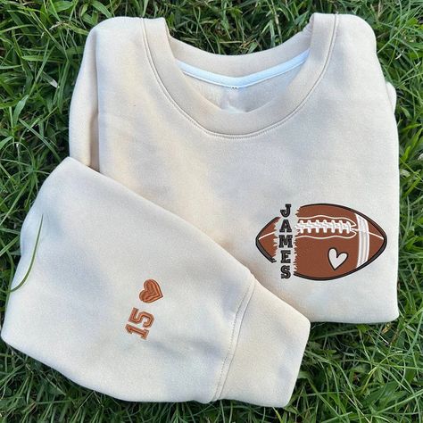 Personalized Football Embroidered Sweatshirt, Game Day Sweatshirt, Custom Football Name And Number On Sleeve Embroidered Sweatshirt Our sweatshirts are 100% embroidered one by one with great care and dedication. They are 100% cotton and double stitched on the sleeves. Great as Birthday gifts or Holiday presents. This adorable item can be designed upon anyone's wish with any title. Maintenance instructions:-Washing and gentle drying under 30 °.-Iron at low temperature inside out or between two sh Football Hoodie Ideas, Football Sweatshirt Designs, Gifts For Football Players, Football Girlfriend, Football Crewneck, Football Names, Game Day Sweatshirt, Football Shirt Designs, Embroidered Material