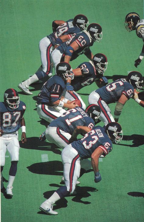 New York Football Giants' 1986 Offensive Line vs San Diego Chargers, Giants Stadium 14/9/86. QB Phil Simms (11) takes the snap from Centre Bart Oates (65). Protecting Simms are, from the top: Tight End, Mark Bavaro (89); Left Tackle, Brad Benson (60); Left Guard, Billy Ard (67); Right Guard, Chris Godfrey (61) and Right Tackle Karl Nelson (63). Behind the line, Wide Receiver Solomon Miller (87) is Man-in-Motion. Big Blue won 20-7 and would later win Superbowl XXI in Pasadena. Happy days! Nfl Legends, Ny Giants Football, Nfl Highlights, Giants Stadium, Nfl Football Pictures, New York Giants Football, New York Football, Nfl Football Players, Nfl Photos