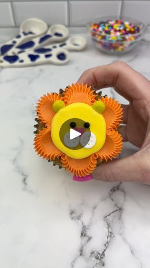 2.7M views · 41K reactions | 🦁🧡 Lion cupcakes 💛🦁 Guys, let’s make a cupcake zoo together 🧁 Starting with the king of the jungle 🦁🧁 Which animal should we add next? 🦁 Use an open star piping tip and orange buttercream to pipe dots around the edge of the cupcakes. 🦁 Using the pipe and swipe technique, spread the dots into the centre, using a small piping tip. 🦁 Use a round piping tip to add a large dollop of yellow buttercream to the middle of the cupcake. Smooth it with a spatula.🦁 Add two yellow mini M and Ms for ears and a heart sprinkle for the nose.🦁 Add two white fondant circles for the cheeks, using a toothpick to add dots. 🦁 Use two black sprinkles for his eyes. #cupcake #cupcakedecorating #animalcupcakes #cakedbyrach #tutorial | Caked By Rach | Jungle · I've Been In Lov Open Star Piping Tip, Star Piping Tip, Zoo Animal Cupcakes, Tiger Cupcakes, M And Ms, Lion Cupcakes, Specialty Cupcakes, White Fondant, Orange Buttercream