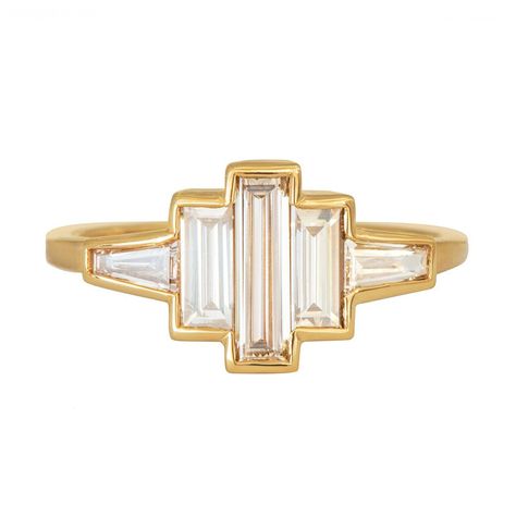 Art deco baguette diamond ring features a spectacular array of five baguette diamonds whose form is then traced with gold. This ring has much vintage charm and modern glam.  The design is inspired by the elegant and glamorous art deco style, characerised by smooth lines, geometric shapes and streamlined forms.  #jewelry #EyeOnJewels #Diamonds #Gold #artdecobaguette #fashion #ring #stylish #glamourousart #elegant #vintagecharm #modernglam Geometric Diamond Ring, Brown Diamond Ring, Unusual Engagement Rings, Baguette Engagement Ring, The Bling Ring, Trending Engagement Rings, Baguette Diamond Rings, Ring Trends, Cluster Engagement Ring