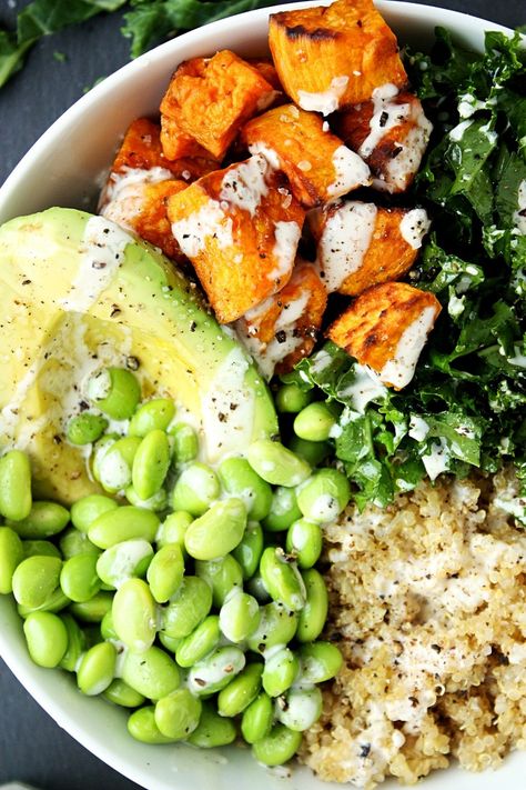 Kale Quinoa Sweet Potato Buddha Bowl Recipe || Made with chopped fresh kale, roasted sweet potatoes, quinoa, avocado, and edamame, and topped with a creamy tahini dressing. #mondaysundaykitchen #buddhabowlrecipes #buddhabowl #besthealthybowls #healthysaladrecipes #sweetpotatobuddhabowl #quinoabuddhabowl #kale Sweet Potato Buddha Bowl, Potato Buddha Bowl, Edamame Recipes, Kale Quinoa, Sweet Potato Bowls, Quinoa Sweet Potato, Buddha Bowls Recipe, Kale Recipes, Healthy Bowls