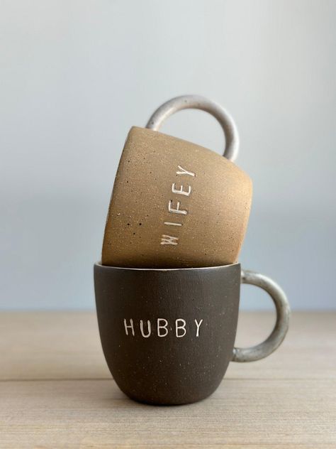 These handmade Hubby & Wifey Mugs make the perfect gift to personalize for any couple! Crafted with love, you can choose from a variety of colors to make these ceramic mugs totally unique. Perfect for celebrating anniversaries, weddings ,house warmings or Christmas ☺️ Listing price is for a pair lovingly set in natural wood gift box and includes 4 seasonal teabags Listing price is per mug or for pair MEASURES :approx. 4" wide x 4" tall - Holds approximately 16oz Why You’ll Love It Dishwasher & M Alaska Cabin, Wildflower Drawing, Matching Mugs, Big Mug, Pottery Inspo, Wood Gift Box, Mugs Gift, Wedding Mugs, Cafe Art