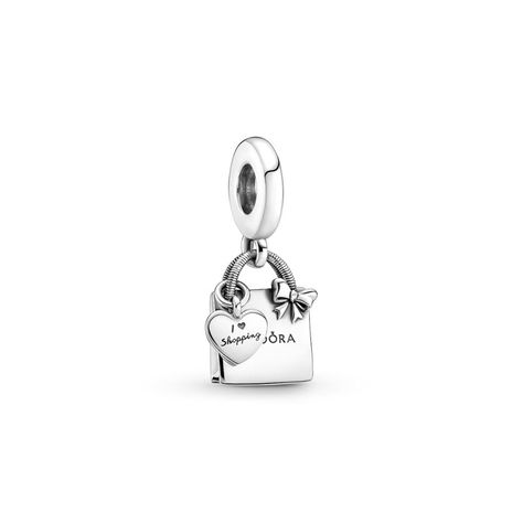 Wear a playful nod to your love of shopping with the PANDORA Shopping Bag Dangle Charm. This heart bag charm is hand-finished in sterling silver, features an engraved PANDORA logo on the front and back, plus a delicate bow detail on the front. A separate dangling heart-shaped bag tag includes the engraved message. This charm is ideal for you if you adore shopping and are looking for a sleek, polished silver addition to your look.   Grace & Co have been authorised PANDORA UK retailers for ove Pandora Shopping Bag Charm, Pandora Bag Charm, Pandora Shopping Charm, Heart Pandora Charm, Pandora Cute Charms, Pandora Silver Charms, Aesthetic Pandora Charms, Pandora Shopping Bag, Pandora Chain Bracelet